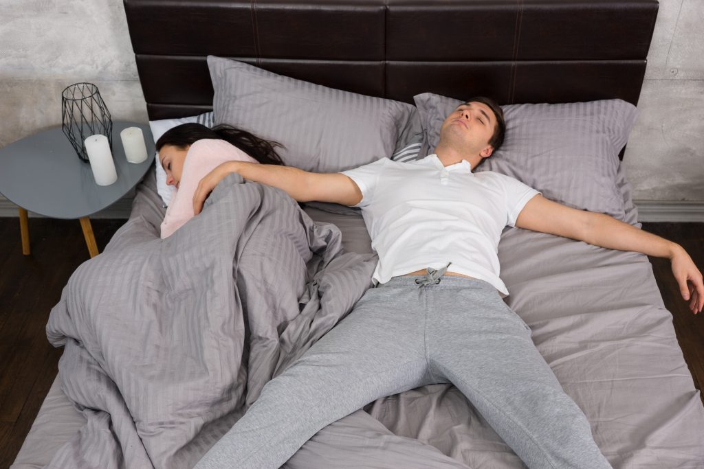 Couple in bed man freewill sleeping position
